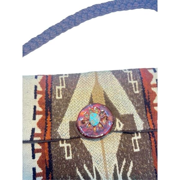 This is a bohemian-style shoulder bag with a braided strap. - Picture 5 of 8